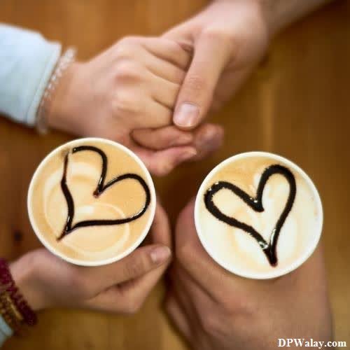 two people holding coffee cups with hearts drawn on them dp pic love