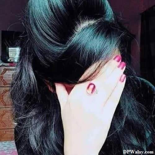 a woman with long black hair and pink nails images by DPwalay