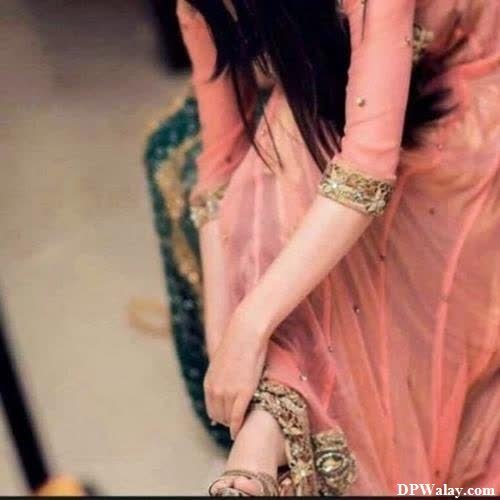 girls dp - a woman in a pink dress with a gold and green blouse