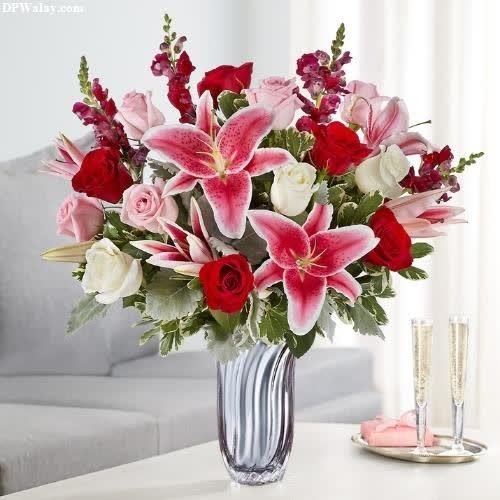 a vase filled with pink and red flowers-nC3n 