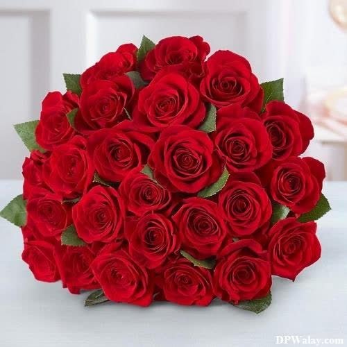 a bouquet of red roses on a table