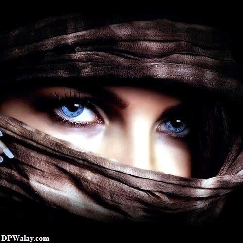 a woman with blue eyes and a scarf over her head-JIwo