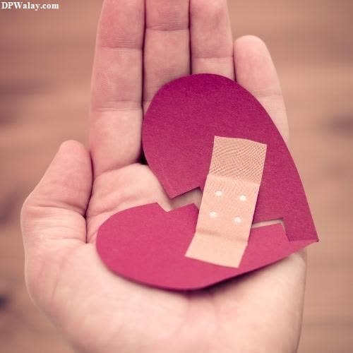 a hand holding a piece of paper with a heart cut in it girls dp pinterest