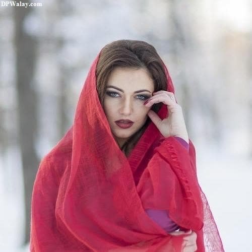 sad girl dp - a woman in a red shawr is standing in the snow