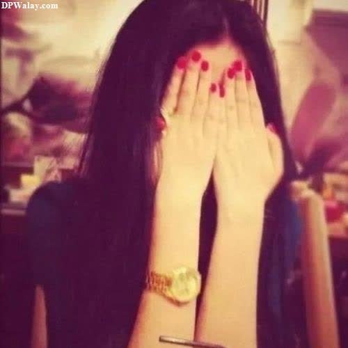 girls dp - a woman with long black hair and red nails covering her face