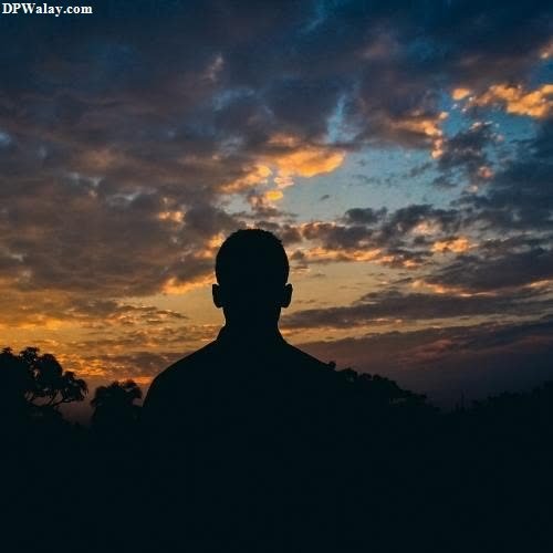 a silhouette of a man in the sunset 