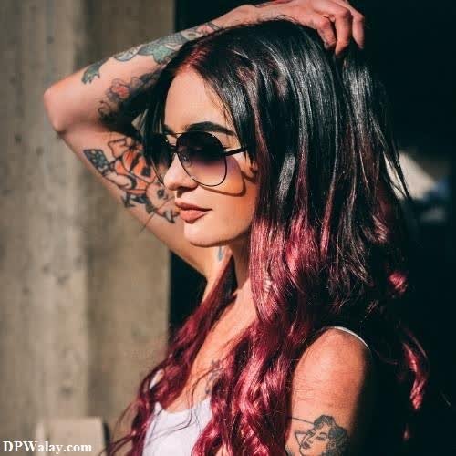 a woman with long red hair and sunglasses images by DPwalay