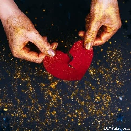 i hate love dp - a person holding a red heart in their hands