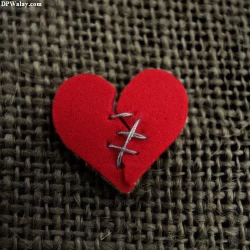 a red heart with a cross on it-Xh0o heart broken dp for whatsapp 