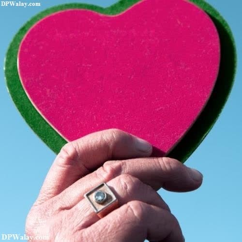 a person holding a heart shaped object in their hand heart dp for whatsapp profile