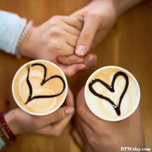 two people holding coffee cups with hearts drawn on them heart dp for whatsapp profile