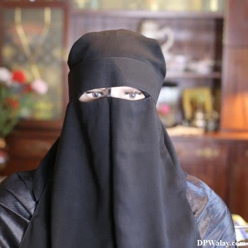a woman wearing a black veil and a black jacket