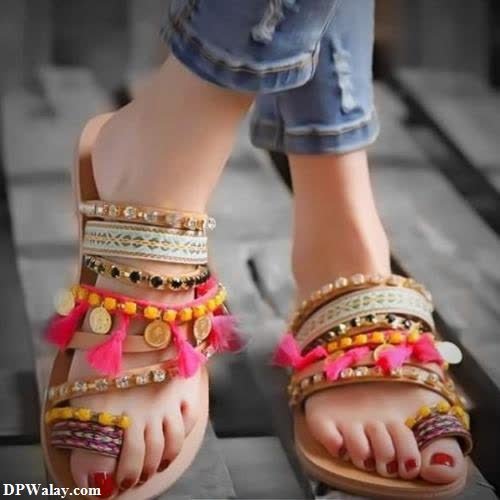 a person wearing sandals and sandals with colorful beads