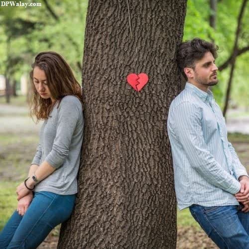 a couple sitting on the ground next to a tree i hate love dp download 