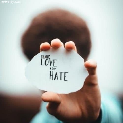 a child holding a piece of paper with the words love hate