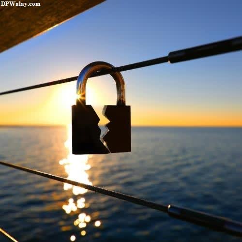 a padlock on a boat at sunset