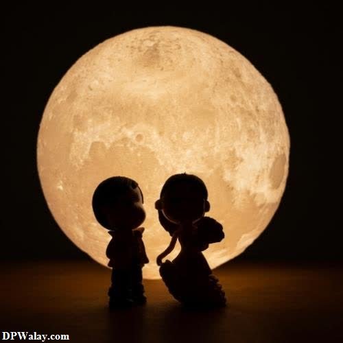 a couple kissing under the moon