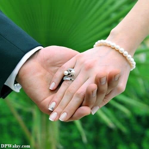 a couple holding hands with a ring on their finger instagram love dp