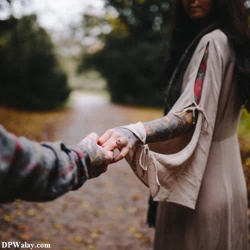 a couple holding hands in the woods instagram love dp 