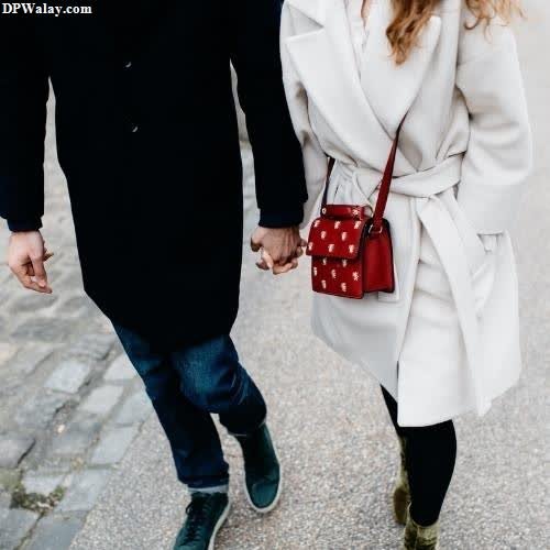 a couple walking down the street holding hands