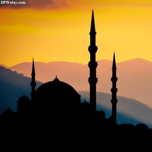 a silhouette of a mosque at sunset