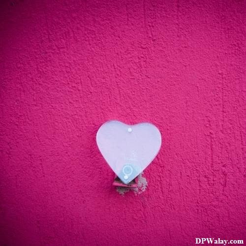 a heart shaped object on a pink wall love dp profile
