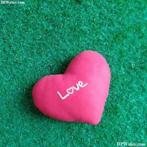 a heart shaped rock with the word love written on it love symbol images for whatsapp dp