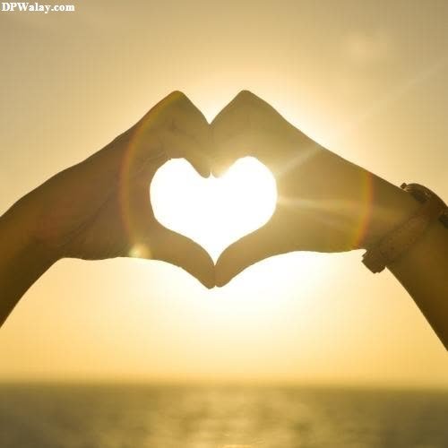 two hands making a heart shape with the sun setting in the background-g3GU love symbol images for whatsapp dp 