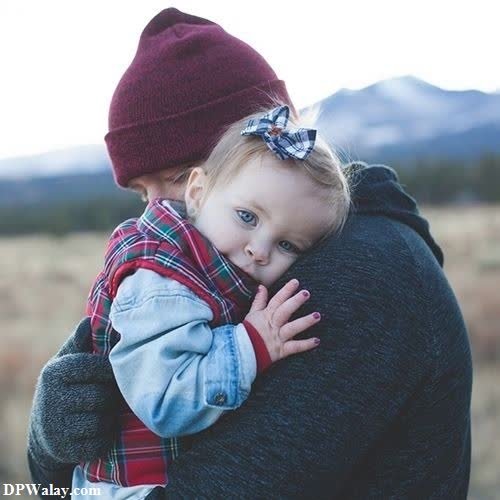 a woman holding a child in her arms mom and dad dp