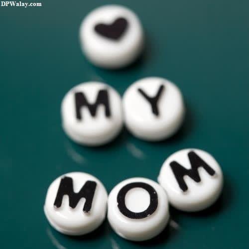 a green background with white and black letters spelling the word mom 