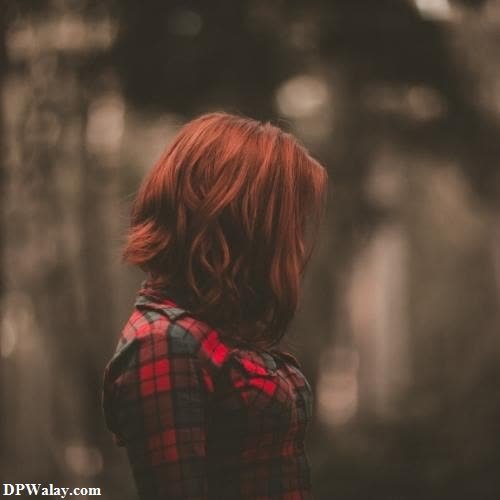 a woman with red hair standing in the woods images by DPwalay