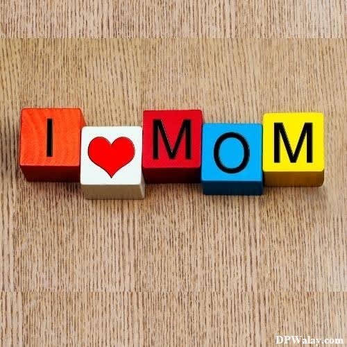 a wooden block with the word mom spelled in it mum dad photo 