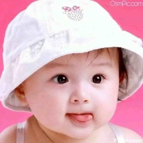 a baby girl wearing a white hat