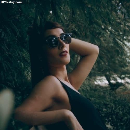 a woman in a black dress and sunglasses new dp for girls