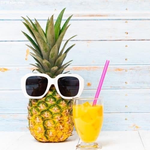 a pineapple with sunglasses and a drink