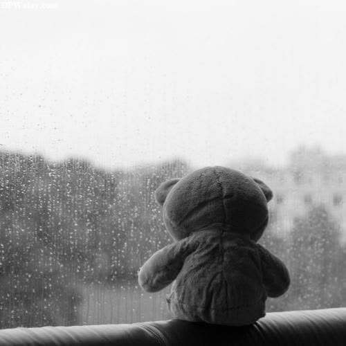 a teddy bear sitting on a window sie 