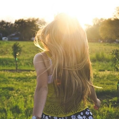a woman with long blonde hair walking through a field pics for dp for girls 