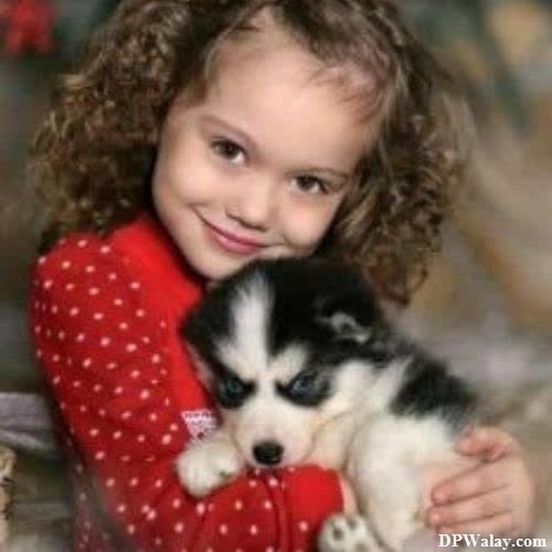 a little girl holding a puppy puppy 