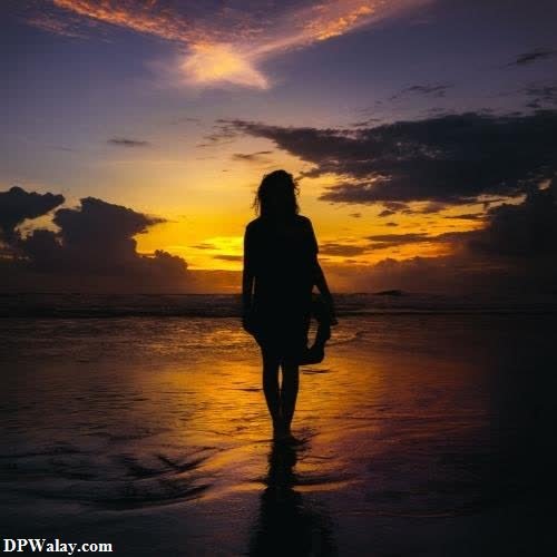 a woman walking on the beach at sunset images by DPwalay