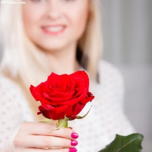 a woman holding a red rose in her hand-ZVYp profile love dp