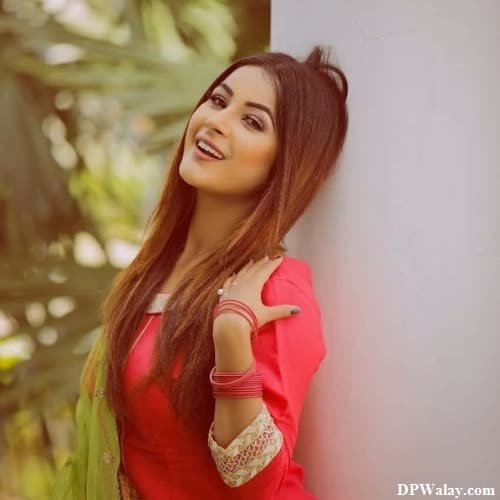 a beautiful young woman in a red dress posing against a wall punjabi dp girl