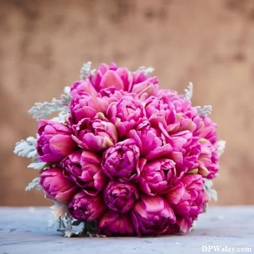 a bouquet of pink flowers on a table 