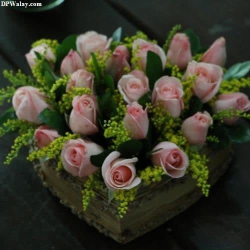 a wooden box with pink roses in it 