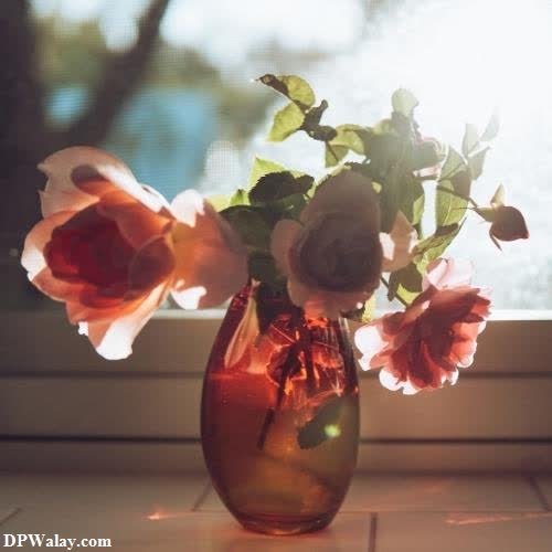 a vase with flowers in it sitting on a window sie