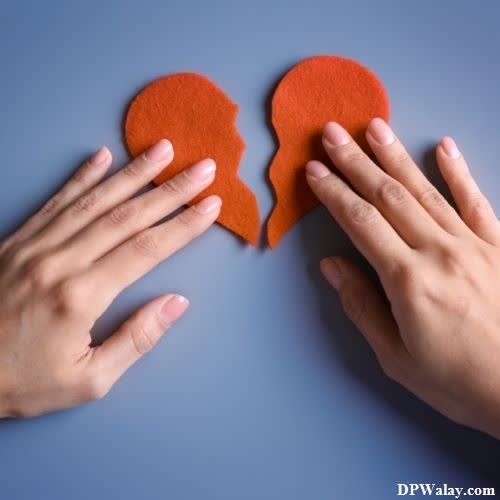 two hands holding red felt hearts
