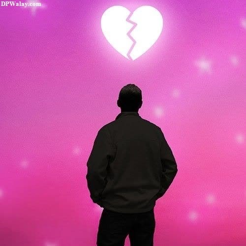a man standing in front of a pink wall with a broken heart-B1pL