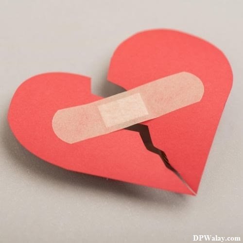a broken heart with a piece of paper on it sad broken heart dp 