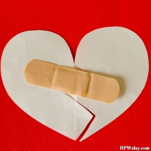sad girl dp - a heart shaped piece with bandages on it