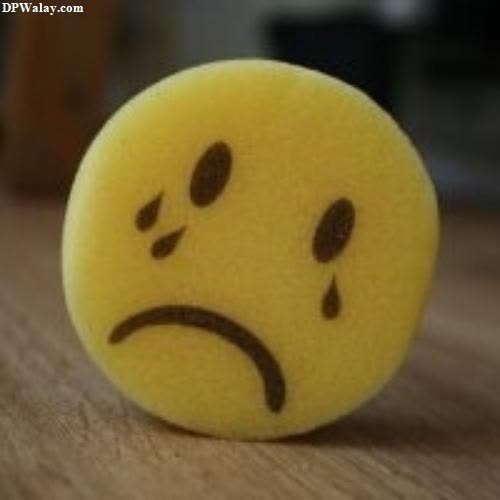 a yellow ball with a sad face on it 