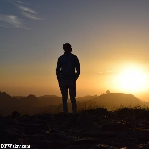 sad girl dp - a man standing on top of a mountain at sunset